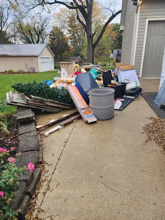 Dumpster being loaded with debris for Estate Cleanout Dumpster Rental in Farley
